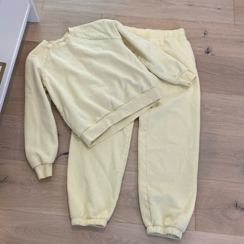 TNA sweat suit in pale yellow.